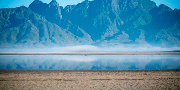 A picture taken on May 10, 2017 shows bare sand and a narrow body of water facing the sky at Theewaterskloof Dam, which has less than 20% of it's water capacity, near Villiersdorp, about 108Km from Cape Town.