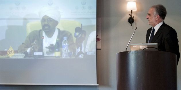 ICC’s former chief prosecutor Luis Moreno-Ocampo looks at a video of Sudan’s President Omar al-Bashir.