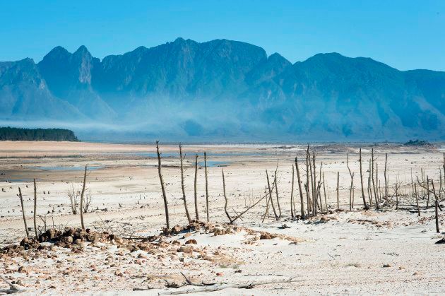 A picture taken on May 10, 2017 shows bare sand and dried tree trunks standing out at Theewaterskloof Dam, which had less than 20% of it's water capacity at the time, near Villiersdorp, about 108km from Cape Town.