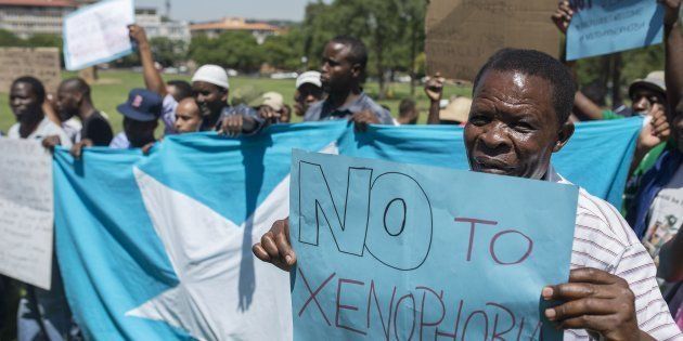 Protesters hold banners during a rally held to protest against xenophobia at Burgers Park in Pretoria, South Africa on March 9, 2017. Protesters demanded to end violence towards foreigners as they marched to government building.