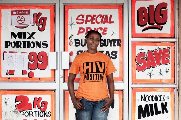 Nelwiswa Nkwali, 34, poses for a portrait outside a supermarket while wearing a T-shirt indicating that she is HIV-positive, in Khayelitsha, February 15, 2010. After being diagnosed with HIV in 2001, Nkwali became a peer counsellor with Treatment Action Campaign (TAC), helping to educate others about HIV/AIDS.