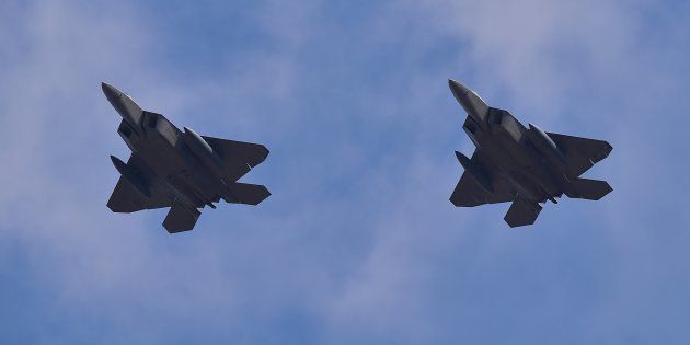 US F-22 stealth fighters fly over Osan Air Base in Pyeongtaek, south of Seoul, on February 17, 2016.