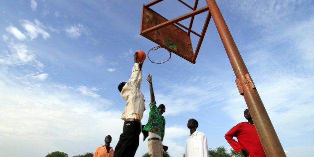 A basketball team plays a game before the arrival of the body of Sudan-born NBA star Manute Bol in the town of Turalei in Warap state, southern Sudan July 4, 2010.