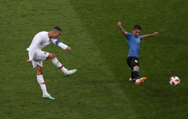 Portugal's Cristiano Ronaldo shoots at goal under pressure from Uruguay's Lucas Torreira during their Fifa World Cup round of 16 match at the Fisht Stadium, Sochi, on Saturday, June 30.