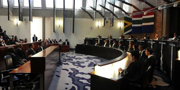 South African Chief justice Mogoeng Mogoeng (2nd from R top row) reads the ruling during the judgment in the matter of Democratic Alliance vs. Speaker of the National Assembly and others at the Constitutional Court in Johannesburg on March 31, 2016. South Africa's top court delivered a damning verdict against President Jacob Zuma, saying he flouted the constitution over public funds used to upgrade his private residence, sparking immediate calls for him to be impeached. Zuma 'failed to uphold, defend and respect the constitution as the supreme law of the land,' Chief Justice Mogoeng Mogoeng said in a strongly-worded ruling from the Constitutional Court in Johannesburg. / AFP / POOL / felix dlangamandla (Photo credit should read FELIX DLANGAMANDLA/AFP/Getty Images)