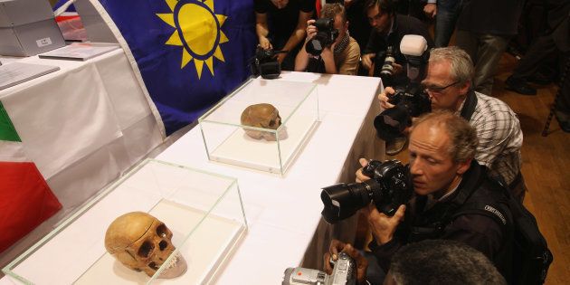 Journalists photograph two of 20 skulls to be taken possession of by a delegation from Namibia at a ceremony at Charite hospital on September 30, 2011 in Berlin, Germany. The skulls are from Herero and Nama tribespeople taken by German colonial forces between 1904 and 1908, when the Germans violently suppressed an uprising in what was then German Southwest Africa, which is today's Namibia, and in the process killed tens of thousands of Herero and Nama. German scientists at the time took the skulls back to Berlin to demonstrate the racial superiority of Europeans over black Africans. Many Namibians demand a formal apology from the German government.