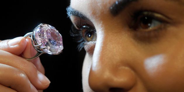 A model poses with a 59.60-carat mixed cut diamond known as