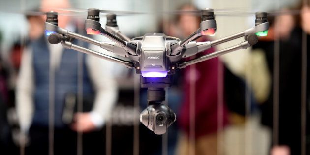 Visitors look at a drone at the booth of Chinese company Yuneec at the world's biggest computer and software fair, CeBit, in Hanover, Germany, on March 20, 2017. This is the sort of technology that's now helping establish property records where there aren't any.