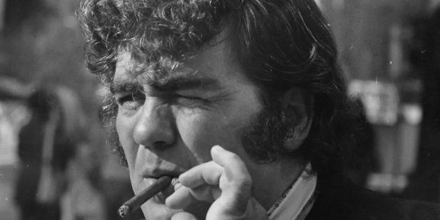 Jimmy Breslin smokes a cigar outside the Madison Hotel in Washington, DC on August 29, 1973.