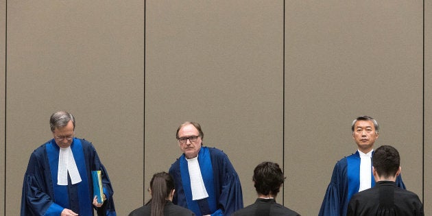 Judge Cuno Tarfusser (C), Judge Chang-ho Chung (R) and Judge Marc Perrin de Brichambautat (L) issue a ruling on South Africa's failure to arrest Sudanese President Omar al-Bashir during a three-day visit in June 2015, during a session of the International Criminal Court in The Hague, Netherlands, July 6, 2017.