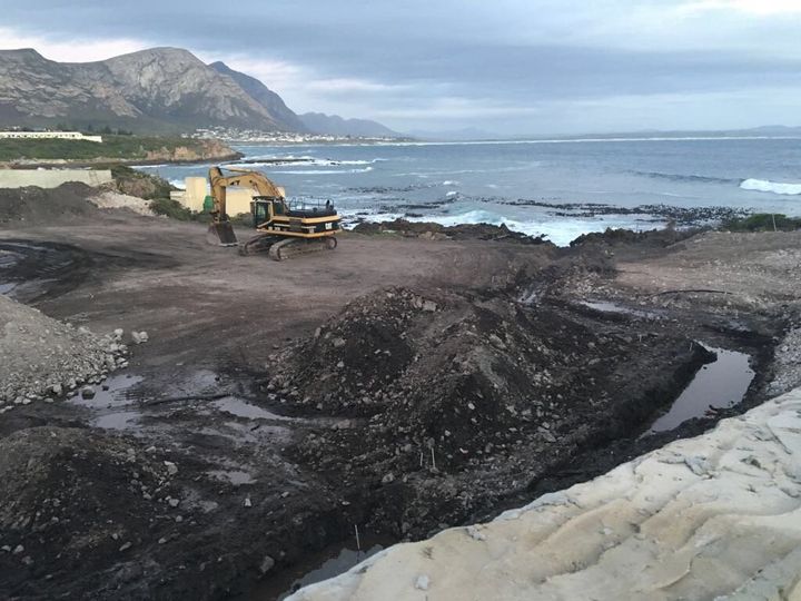 An excavator on the property on the water's edge in Hermanus where former Steinhoff CEO Markus Jooste is building a new holiday home.
