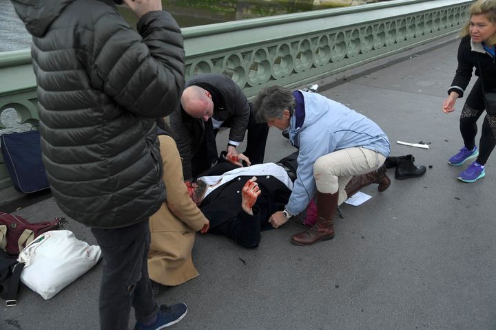 Injured people are assisted after an incident on Westminster Bridge in London, March 22, 2017. REUTERS/Toby Melville