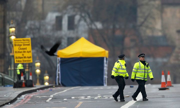 Police officers walk accross Westminster Bridge the morning after an attack by a man driving a car and weilding a knife left five people dead and dozens injured, in London, Britain, March 23, 2017.