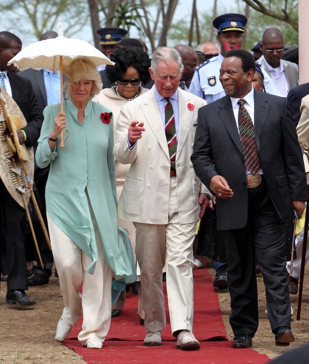 The Prince of Wales and the Duchess of Cornwall accompanied by King Goodwill Zwelethini walk through his Odini Palace grounds in Ulundi.