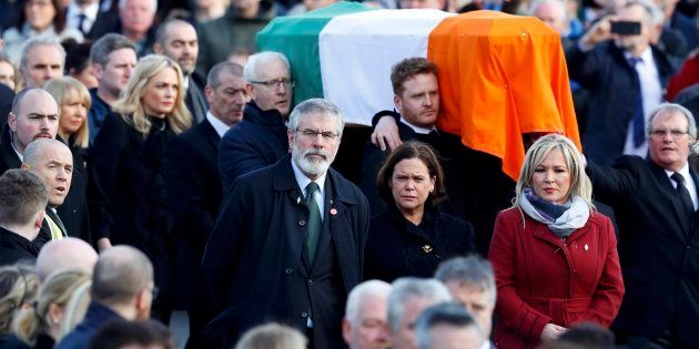 Sinn Feinn President Gerry Adams, centre, walks next to the coffin of Martin McGuinness during his funeral in Londonderry, Northern Ireland, March 23, 2017.