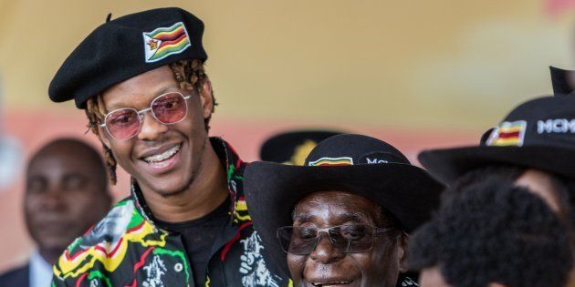 Zimbabwean President Robert Mugabe (C), with his son Robert Jr, smiles at his grandson during his 93rd birthday celebrations hosted at Rhodes Preparatory School in Matopos, Matabeleland South Province, on February 25, 2017.