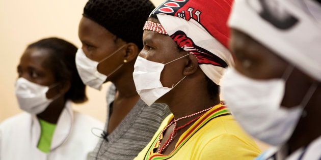 Patients with HIV and tuberculosis (TB) wear masks while awaiting consultation at a clinic in Cape Town's Khayelitsha township, February 23, 2010.