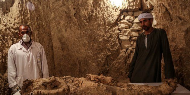 LUXOR, EGYPT - DECEMBER 09: Egyptian archaeologists are seen near an ancient mummified body that belongs to the 18th Dynasty pharaohs (B.C. 1550-1292) in Dra Abu el-Naga district of Luxor, Egypt on December 09, 2017.