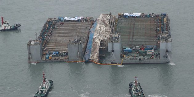 The sunken ferry Sewol is moved toward a semi-submersible ship (not pictured) during its salvage operations at the sea off Jindo, South Korea, on March 24, 2017.