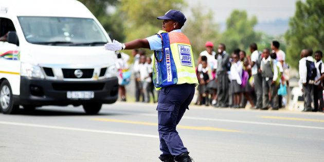 Johannesburg Metro Police Department (JMDP) officer Dorah Mofokeng directs traffic at the corner of Witkoppen and Cedar roads on March 14, 2017 in Fourways, Johannesburg, South Africa. Mofokeng, who started working for JMPD seven years ago, says she entertains motorists because they complain a lot.