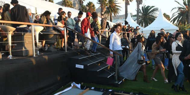 Guests leave the Mercedes-Benz Fashion Week Cape Town in Camps Bay, due to strong winds. This was an opportunity for local fashion designers to showcase their talent.