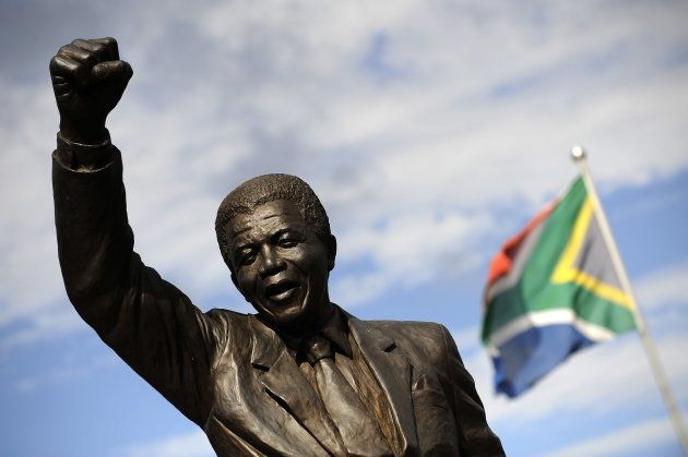 A bronze statue depicting former South African president Nelson Mandela as he walked to freedom in 1990 following his release after 27 years of incarceration, stands outside the Groot Drakenstein prison in Paarl, about 90Kms from Cape Town on the eve of the 20th Anniversary of his liberation. (Photo credit: GIANLUIGI GUERCIA/AFP/Getty Images)