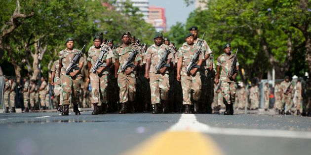 South African National Defence Force (SANDF) soldiers parade on the streets near the Union Buildings in Pretoria on December 12, 2013.