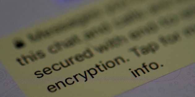 An encryption message is seen on the WhatsApp application on an iPhone in Manchester, Britain March 27, 2017.