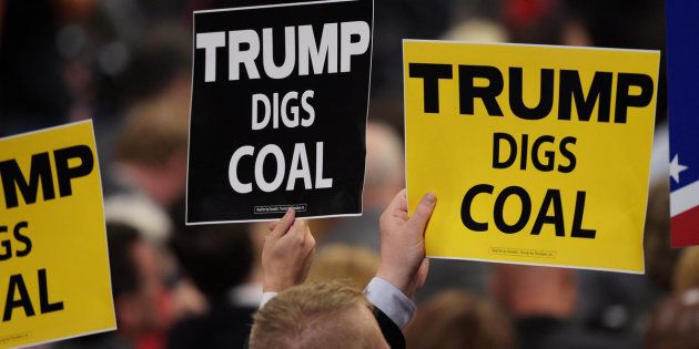 CLEVELAND, OH - JULY 19: Delegates hold signs that read 'Trump Digs Coal' on the second day of the Republican National Convention on July 19, 2016 at the Quicken Loans Arena in Cleveland, Ohio. Republican presidential candidate Donald Trump received the number of votes needed to secure the party's nomination. An estimated 50,000 people are expected in Cleveland, including hundreds of protesters and members of the media. The four-day Republican National Convention kicked off on July 18. (Photo by Jeff Swensen/Getty Images)