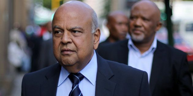 South Africa's Finance Minister Pravin Gordhan walks with his deputy, Mcebisi Jonas as they walk from their offices to a court hearing in Pretoria, South Africa, March 28, 2017.