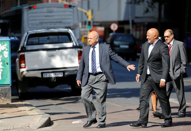 South Africa's Finance Minister Pravin Gordhan (L) gestures to his deputy, Mcebisi Jonas as they walk from their offices to a court hearing in Pretoria, South Africa, March 28,2017. REUTERS/Siphiwe Sibeko