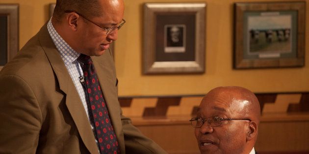 President Jacob Zuma (R) speaks with his lawyer Michael Hulley ahead of a press conference after appearing at the Durban High Court, South Africa, April 7, 2009.