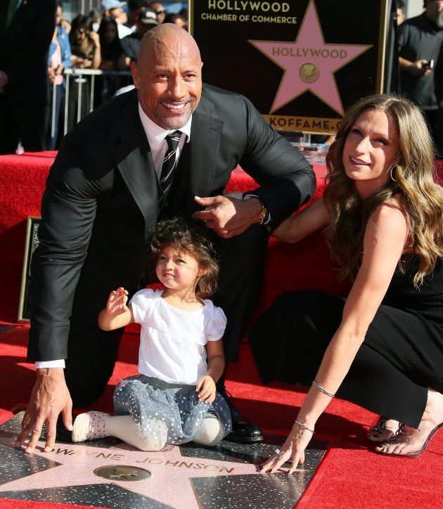 Dwayne Johnson, Lauren Hashian and their daughter Jasmine pose with the actor's star.
