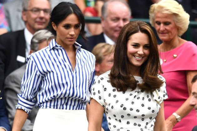 Meghan, Duchess of Sussex, and Catherine, Duchess of Cambridge, attend day twelve of the Wimbledon Lawn Tennis Championships at All England Lawn Tennis and Croquet Club on July 14, 2018 in London. (Photo by Clive Mason/Getty Images)