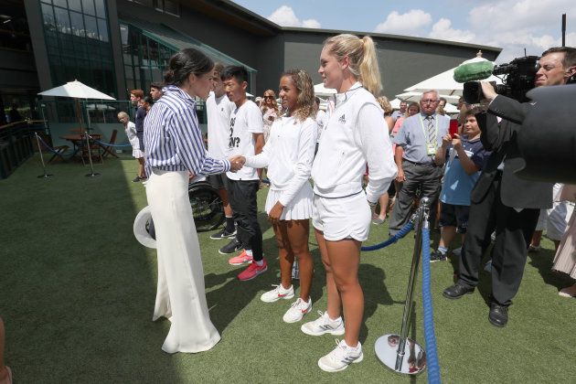 Meghan, Duchess of Sussex, shakes hands at All England Lawn Tennis and Croquet Club on July 14, 2018 in London.