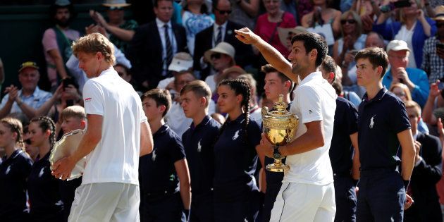 Tennis - Wimbledon - All England Lawn Tennis and Croquet Club, London, Britain - July 15, 2018 Serbia's Novak Djokovic celebrates with the trophy after winning the men's singles final against South Africa's Kevin Anderson.