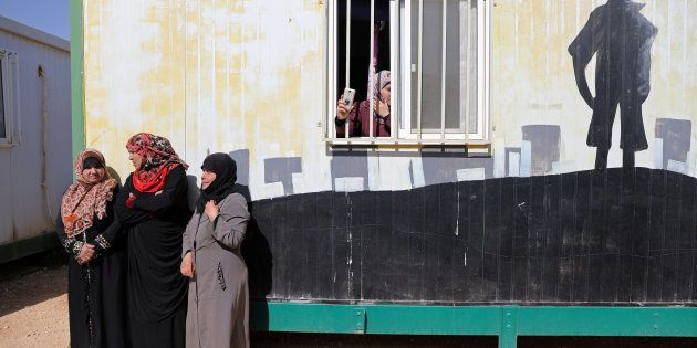 Syrian refugees stand in Al Zaatari refugee camp during United Nations Secretary General Antonio Guterres' visit to the camp near Mafraq, Jordan near the border with Syria March 28, 2017.