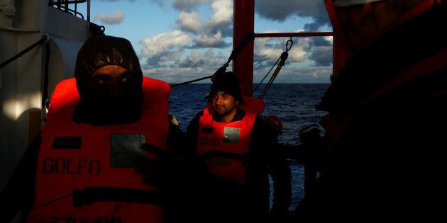 Migrants arrive on the MV Aquarius, a search and rescue ship run in partnership between SOS Mediterranee and Medecins Sans Frontieres, after a mid-sea transfer from MV Open Arms, the search and rescue ship of Proactiva Open Arms, in the central Mediterranean off the coast of Libya, December 16, 2017.