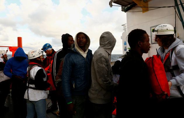 Migrants arrive on the MV Aquarius, a search and rescue ship run in partnership between SOS Mediterranee and Medecins Sans Frontieres, after a mid-sea transfer from MV Open Arms, the search and rescue ship of Proactiva Open Arms, in the central Mediterranean off the coast of Libya, December 16, 2017.