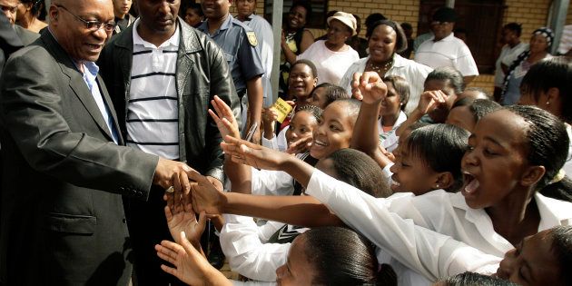 African National Congress (ANC) president Jacob Zuma greets pupils at Bhukulani secondary school in Soweto January 14 2009. Zuma was there to assess conditions under which learners are educated at the school in South Africa's biggest township.