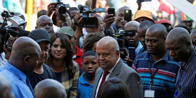South Africa's outgoing Finance Minister Pravin Gordhan, centre, looks on after speaking to supporters outside his offices in Pretoria, South Africa, March 31, 2017.