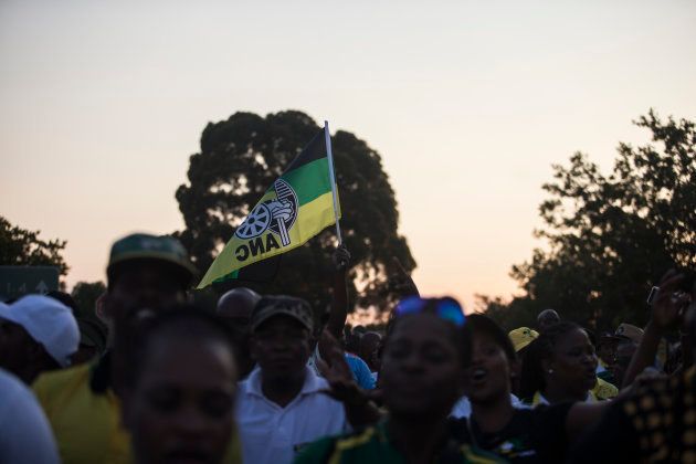 Supporters of Cyril Ramaphosa, South African Vice President and presidential hopeful of the African National Congress hold an ANC flag outside NASREC Expo Centre during the 54th ANC National Conference in Johannesburg, on December 17, 2017. South Africa's ruling African National Congress holds its 54th national conference, with the party expected to elect its new leader, who will probably become the country's next president. / AFP PHOTO / WIKUS DE WET (Photo credit should read WIKUS DE WET/AFP/Getty Images)