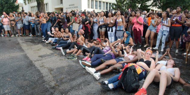 Rhodes University students lie on their backs during protests against sexual violence in the institution on April 19, 2016, in Grahamstown, South Africa. This, after the names of 11 students accused of rape were posted on social media.