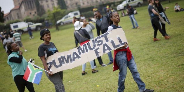 Protesters carry placards as they take part in a 'Zuma must fall' demonstration in Pretoria, South Africa December 16, 2015.