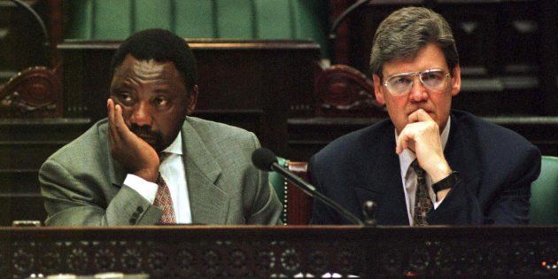 A tired Constitutional Assembly chairperson Cyril Ramaphosa (L) and deputy chairperson Leon Wessels (R) listen to submissions as they work on into the night in an effort to break the deadlocks on South Africa's new Constitution.