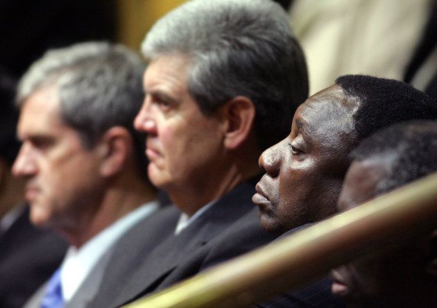 South Africa's constitutional architects Roelf Meyer (L), Leon Wessels and Cyril Ramaphosa (R) listen as former president Thabo Mbeki addresses the Parliament on the 10th anniversary of the Constitution in Cape Town May 8, 2006.