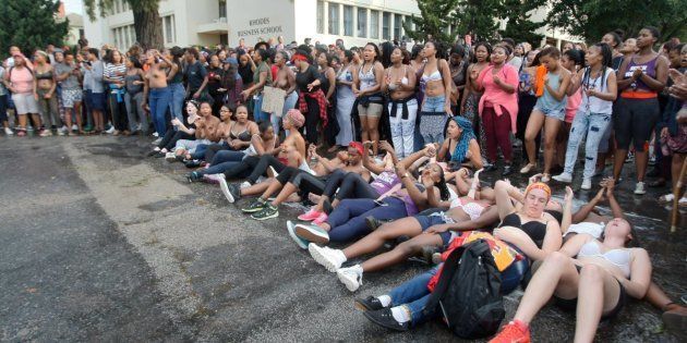 Rhodes University students lie on their backs during protests against sexual violence at the institution on April 19, 2016, in Grahamstown, South Africa. This came after the names of 11 students accused of rape were posted on social media.