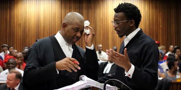 Advocate Dali Mpofu (L) chats to advocate Tembeka Ngcukaitobi during argument in court on a report into allegations of political interference by wealthy friends of President Jacob Zuma, at the North Gauteng High Court, in Pretoria, South Africa, November 2, 2016.