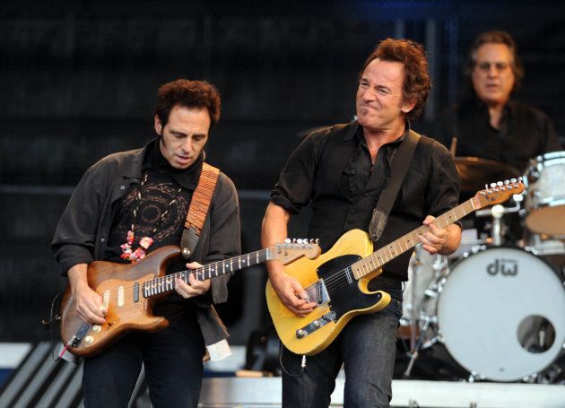 Bruce Springsteen (centre) performs in concert at the Emirates Stadium, in north east London.