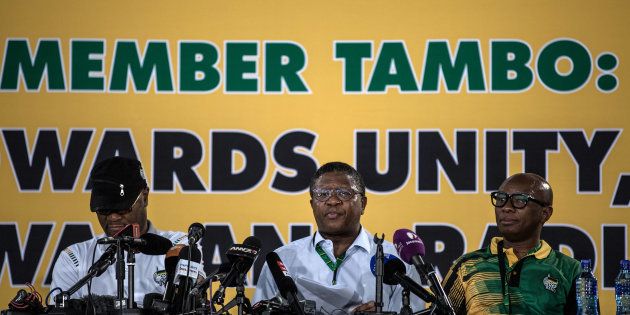 Police minister Fikile Mbalula (C) addresses the media, flanked by arts and culture minister Nathi Mthethwa (L) and African National Congress (ANC) spokesperson Zizi Kodwa, on the final day of the ANC's 54th national conference in Johannesburg on December 20, 2017.